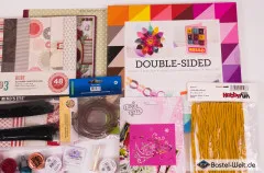 Detailausschnitt mit My-Mind’s-Eye-Glitzerkartonblock „Lost & Found 3 Ruby“ und buntem Double-Sided-Designpapier.